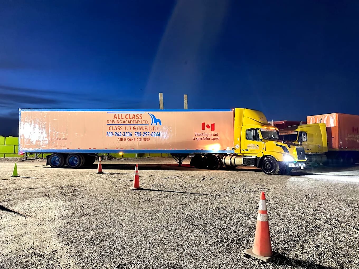 All Class Driving Academy truck at dusk with cones set up for backing practice